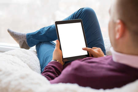 Man using tablet. Tablet vertical screen mockup.の写真素材