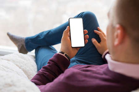 Man using smartphone. Mobile phone screen mockup.の写真素材