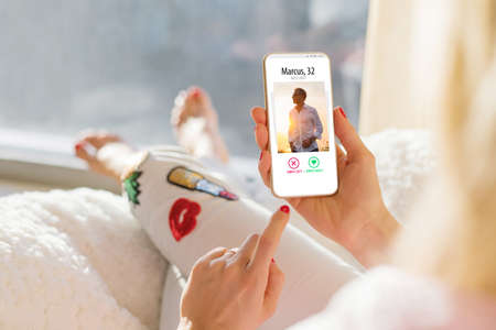 Woman using dating app on mobile phoneの写真素材