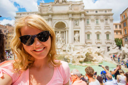 Woman taking selfy photo in front of Trevi fountain in Romeの写真素材