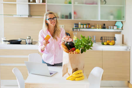 Housewife got her groceries delivered from online storeの写真素材