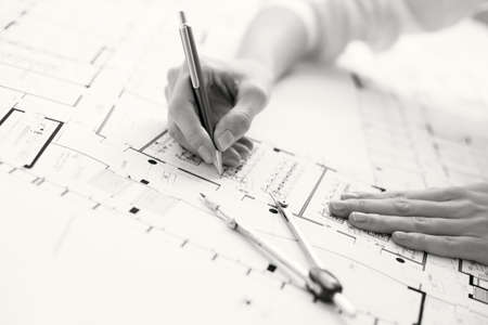 Black and white photo of architect working on house planの写真素材