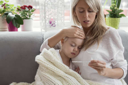 Mother staying at home with her sick childの写真素材