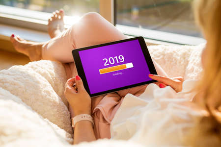 Conceptual image of woman looking at tablet and waiting for New Yearの写真素材
