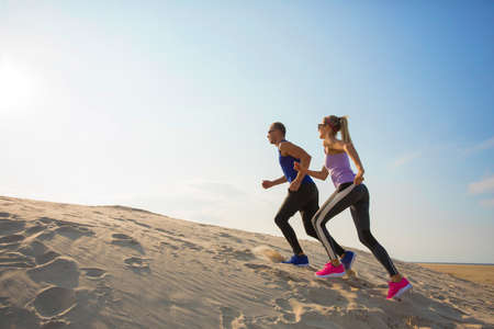 People working out and running up the hill outdoorsの写真素材