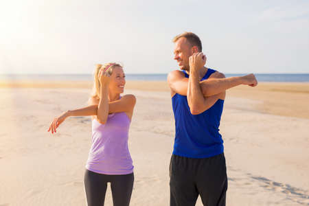 Man and woman stretching before workoutの写真素材