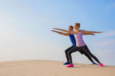 Couple stretching outdoors togetherの写真素材