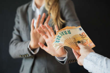 Woman refusing to accept bribe moneyの写真素材
