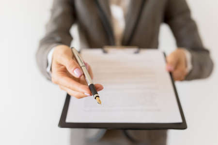 Woman holding ready to sign contract and penの写真素材