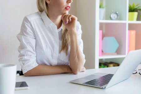 Woman at office sitting at her desk and concentratingの写真素材