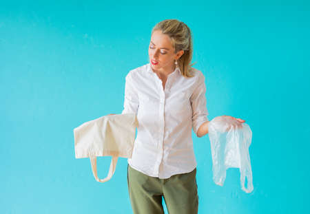 Zero waste concept. Woman choosing to use multi-use bag instead of plastic one.の写真素材