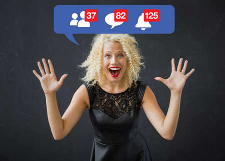 Happy woman excited about notifications on social mediaの写真素材