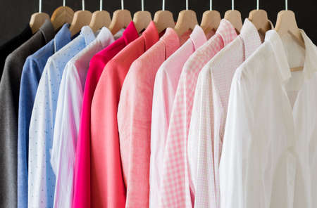 Shirts hanging in rowの写真素材