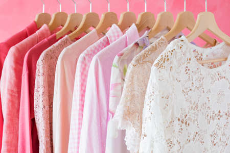 Women's clothes hanging in row on rackの写真素材