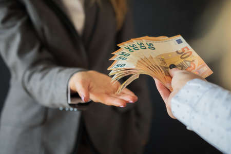 Woman taking bribe moneyの写真素材