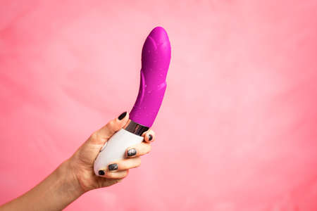 Woman holding vibrator in handの写真素材