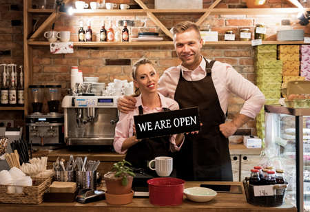 Couple in their new cafe, proud news business ownersの写真素材