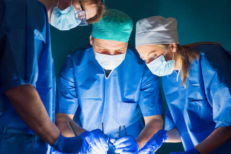 Team of doctors working during surgeryの写真素材