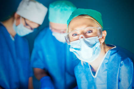 Doctors working in surgery roomの写真素材