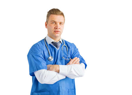 Doctor standing with crossed arms, portrait isolated on white backgroundの写真素材