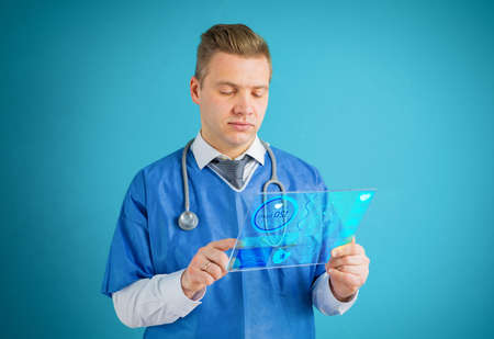 Doctor using futuristic glass tablet computerの写真素材