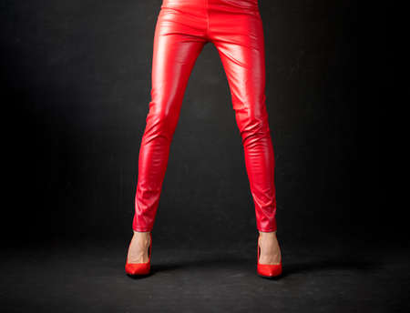 Woman wearing red leather pants and red high heel shoesの写真素材