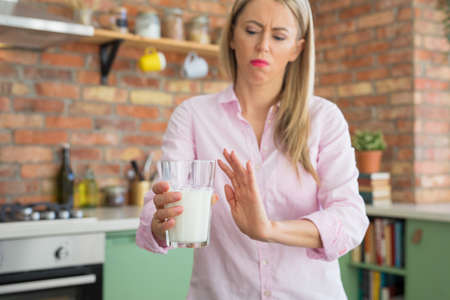 Woman can't drink milk because of lactose intoleranceの写真素材