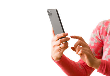Person holding in hands and using mobile phone, photo isolated on white backgroundの写真素材