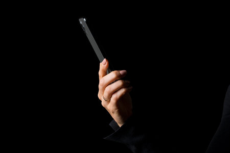 Person holding in hands mobile phone, side view