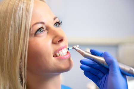 Female patient in dentist office having teeth whitening procedureの写真素材