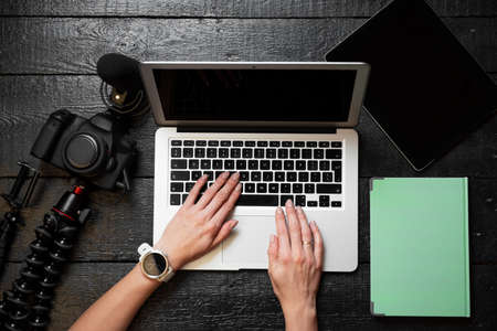 Video blogger using digital camera and computer for content creationの写真素材