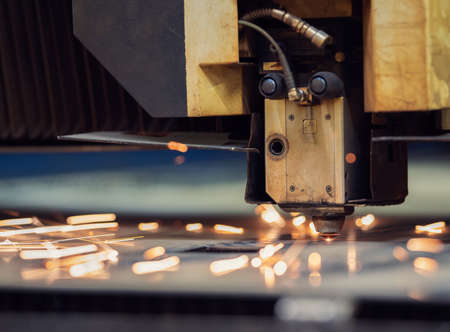 Cutting of metal. Sparks flying from laser machine.の写真素材