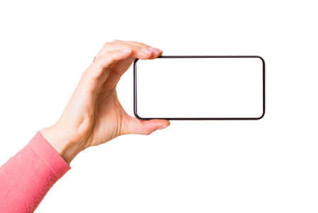 Person holding mobile phone with empty white screen horizontally, photo isolated on white backgroundの写真素材