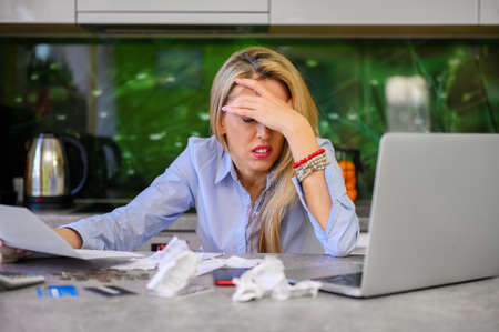 Broke woman calculating her personal financesの写真素材