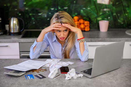 Desperate woman calculating monthly expensesの写真素材