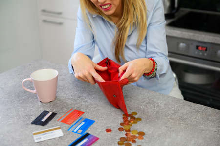 Woman have no money left in wallet and on credit cardsの写真素材
