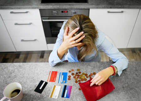 Desperate woman has only some coins leftの写真素材