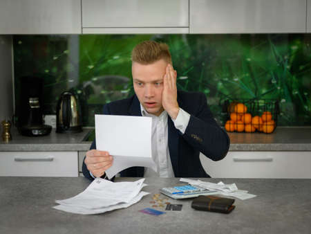 Shocked man reading legal noticeの写真素材
