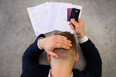 Man in desperation with credit card debtの写真素材