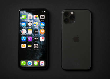 Riga, Latvia - November 28, 2019: Apple iPhone 11 Pro on dark background, front and back sides.のeditorial素材