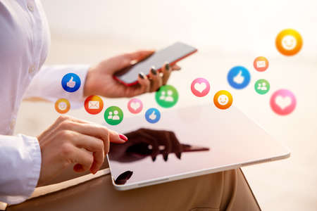 Woman using tech gadgets and apps for everyday lifeの写真素材