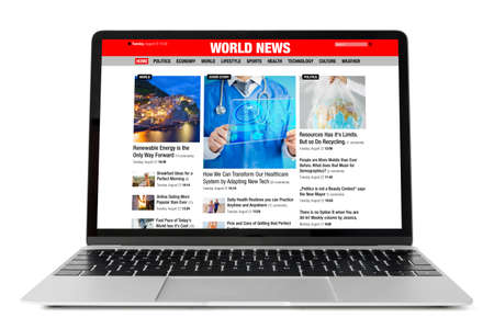 Sample news website shown on laptop computerの写真素材