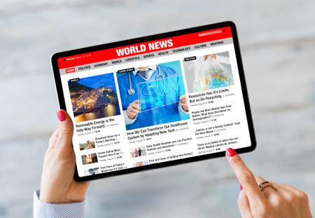 Person holding tablet and reading latest news online