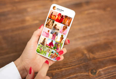 Sample photo gallery of beautiful woman shown on mobile phoneの写真素材