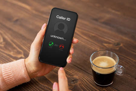 Person receiving a call from an unknown callerの写真素材