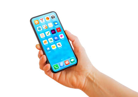 Person holding phone in hand, home screen mockup with app iconsの写真素材