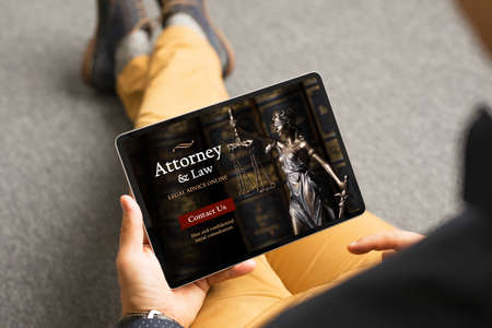 Man looking for legal help and viewing attorney's websiteの写真素材