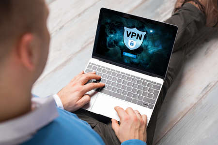Man using VPN (Virtual Private Network) for secure and encrypted connection, also using internet anonymously.の写真素材