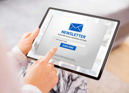 Woman subscribing to weekly newsletter onlineの写真素材