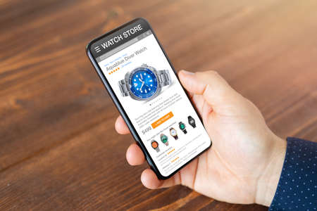 Man shopping for a new watch onlineの写真素材